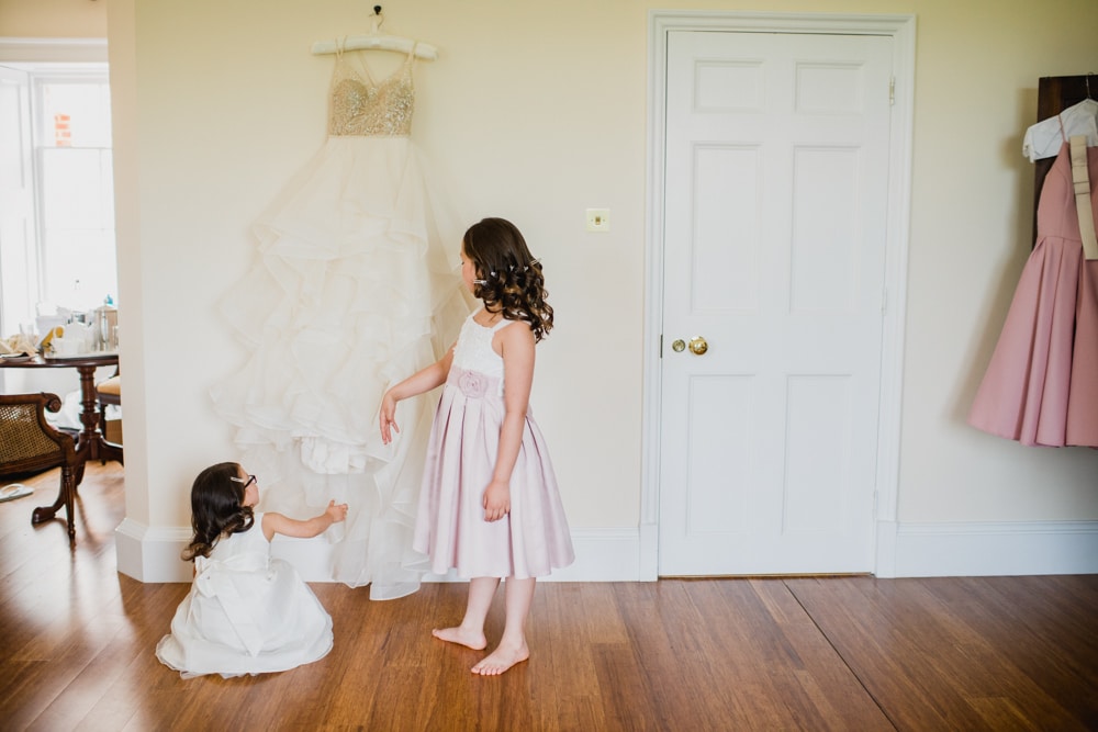 flower girls looking at wedding dress