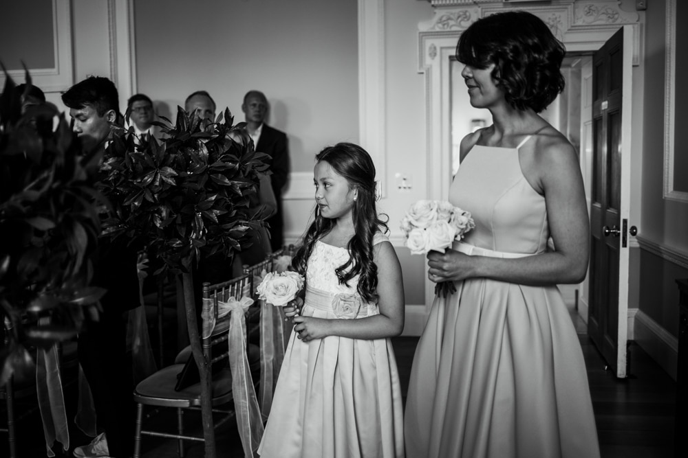 bridesmaid and flower girl walking down aisle