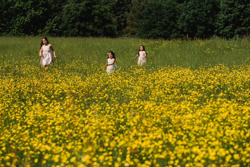 kids running through buttercup field