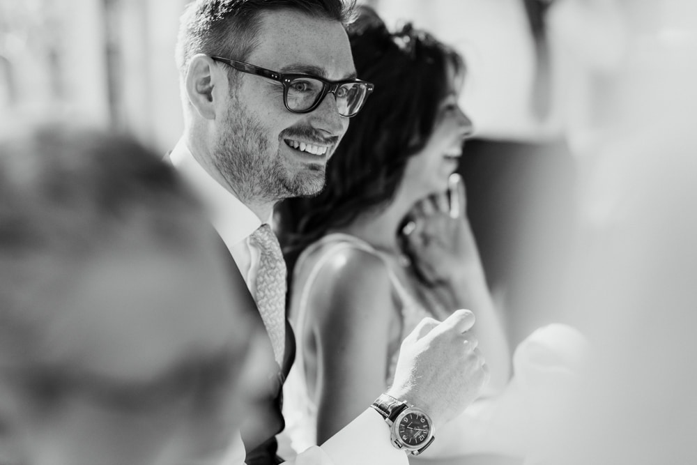 groom smiling during wedding day speeches