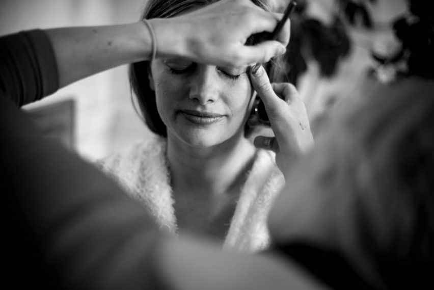 bride having makeup applied