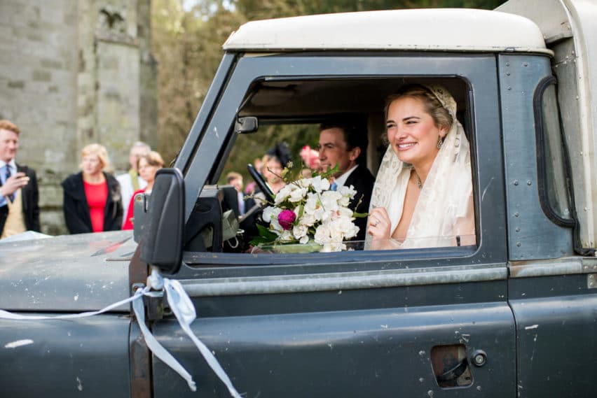 bride and groom in jeep