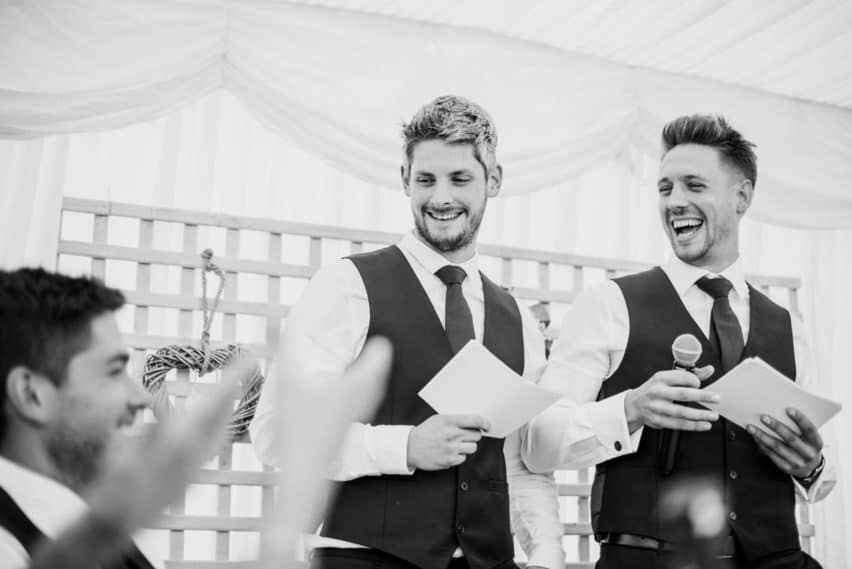 two best men giving their speech at a wedding