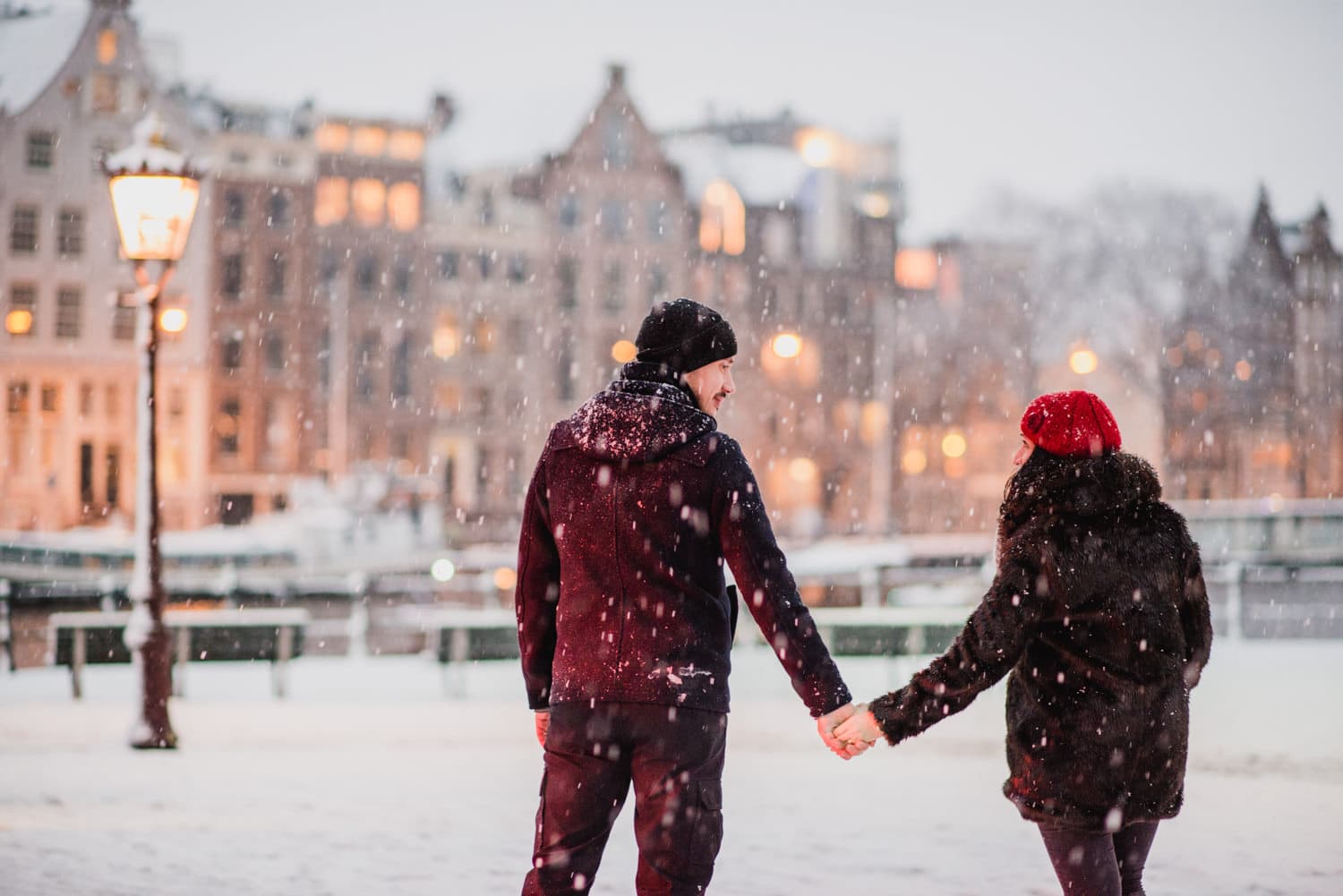 couple holding hands in snow