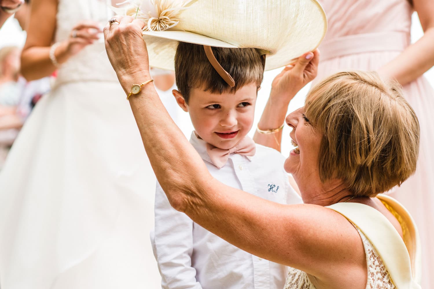 little boy trying on wedding hat