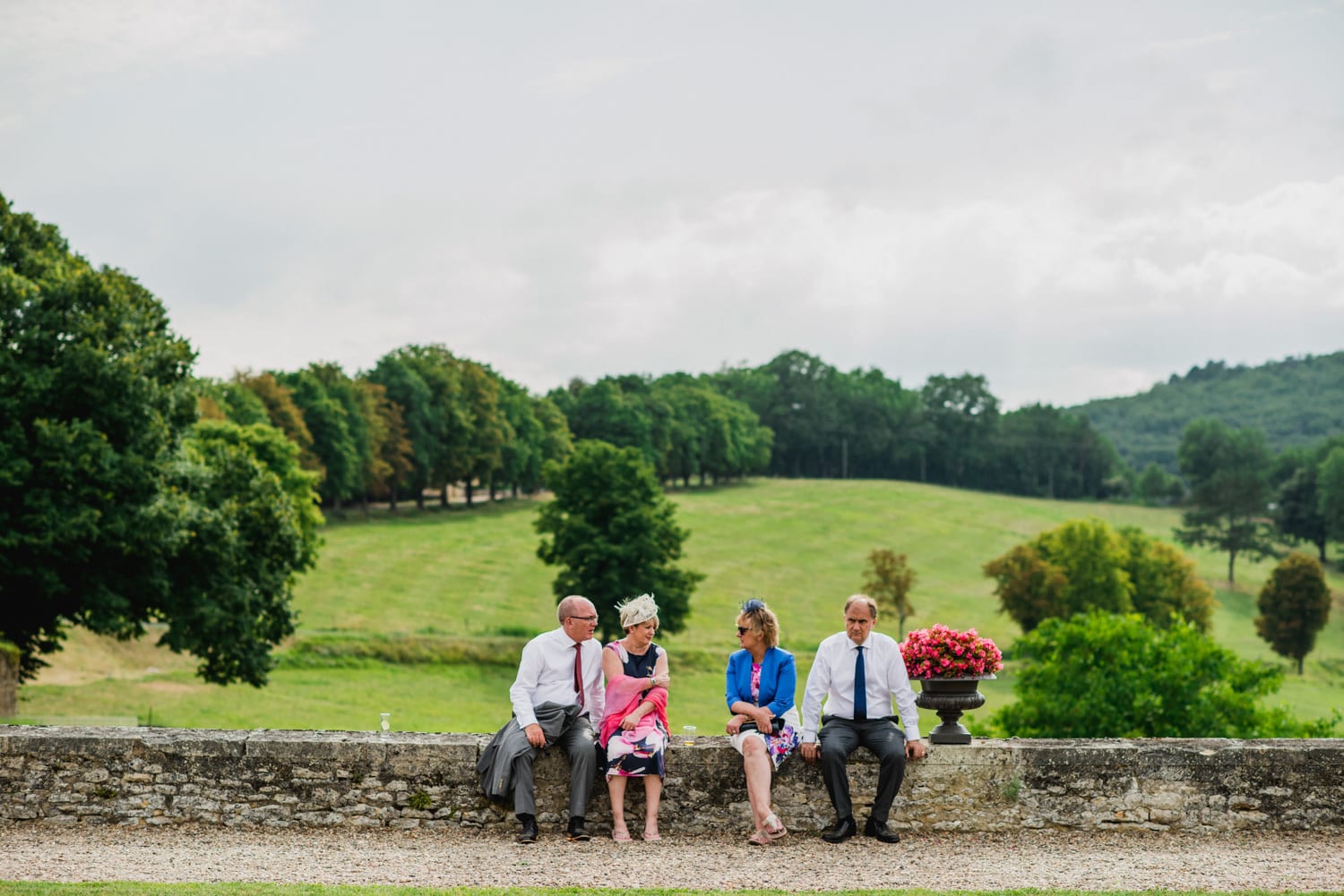 wedding guests sitting on wall