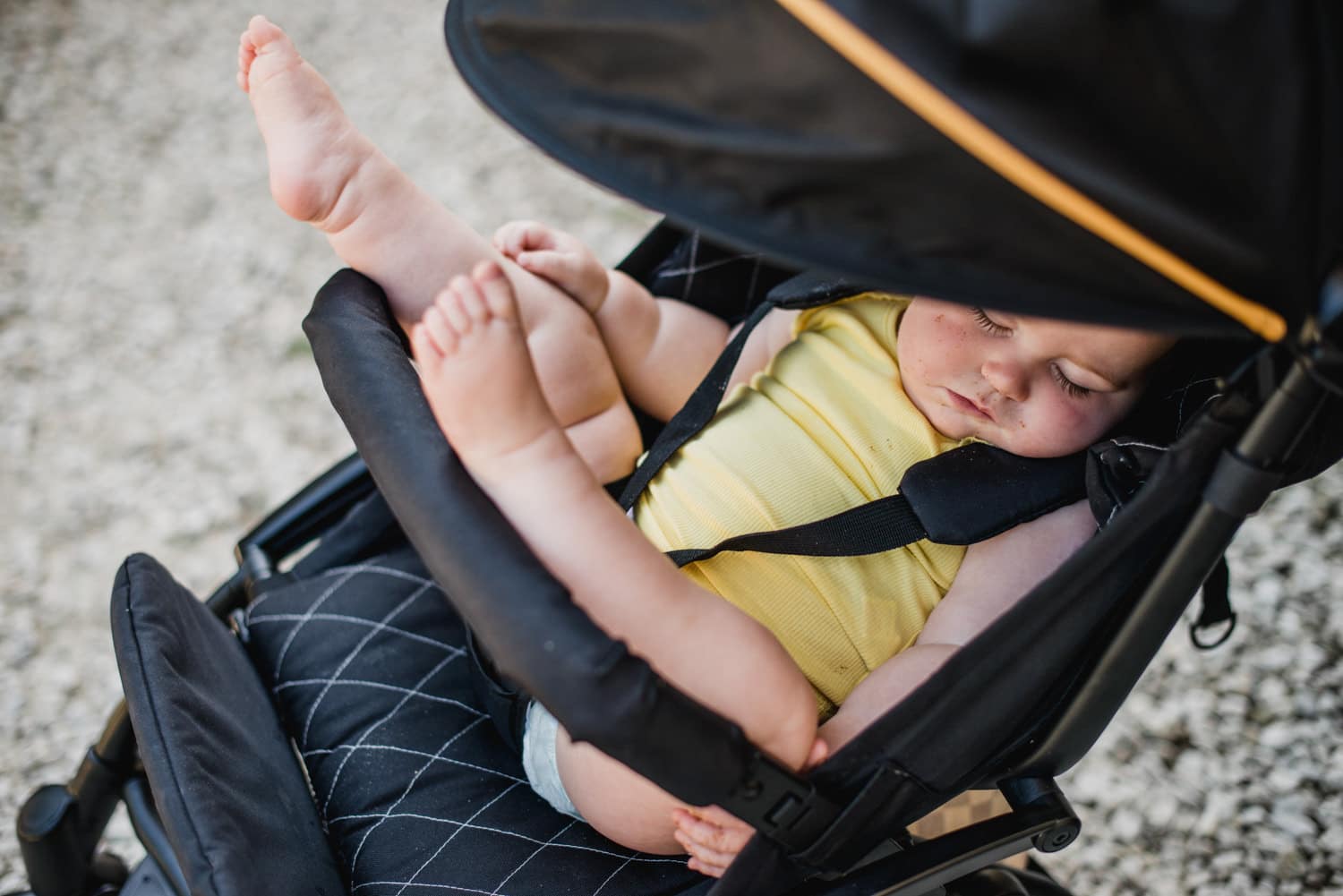 baby sleeping in pushchair at wedding