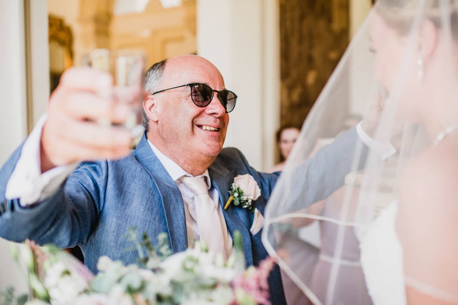 father of bride giving bride a hug