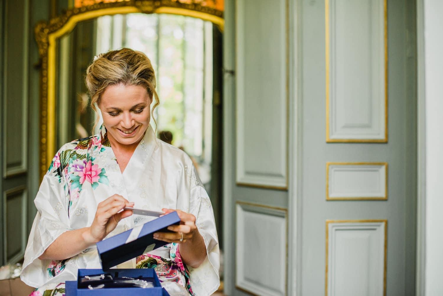 bride opening gift from groom