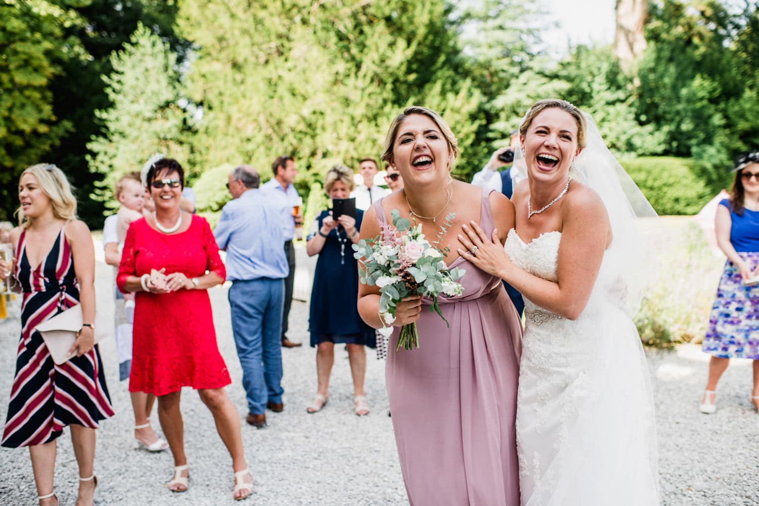 bride and bridesmaid laughing