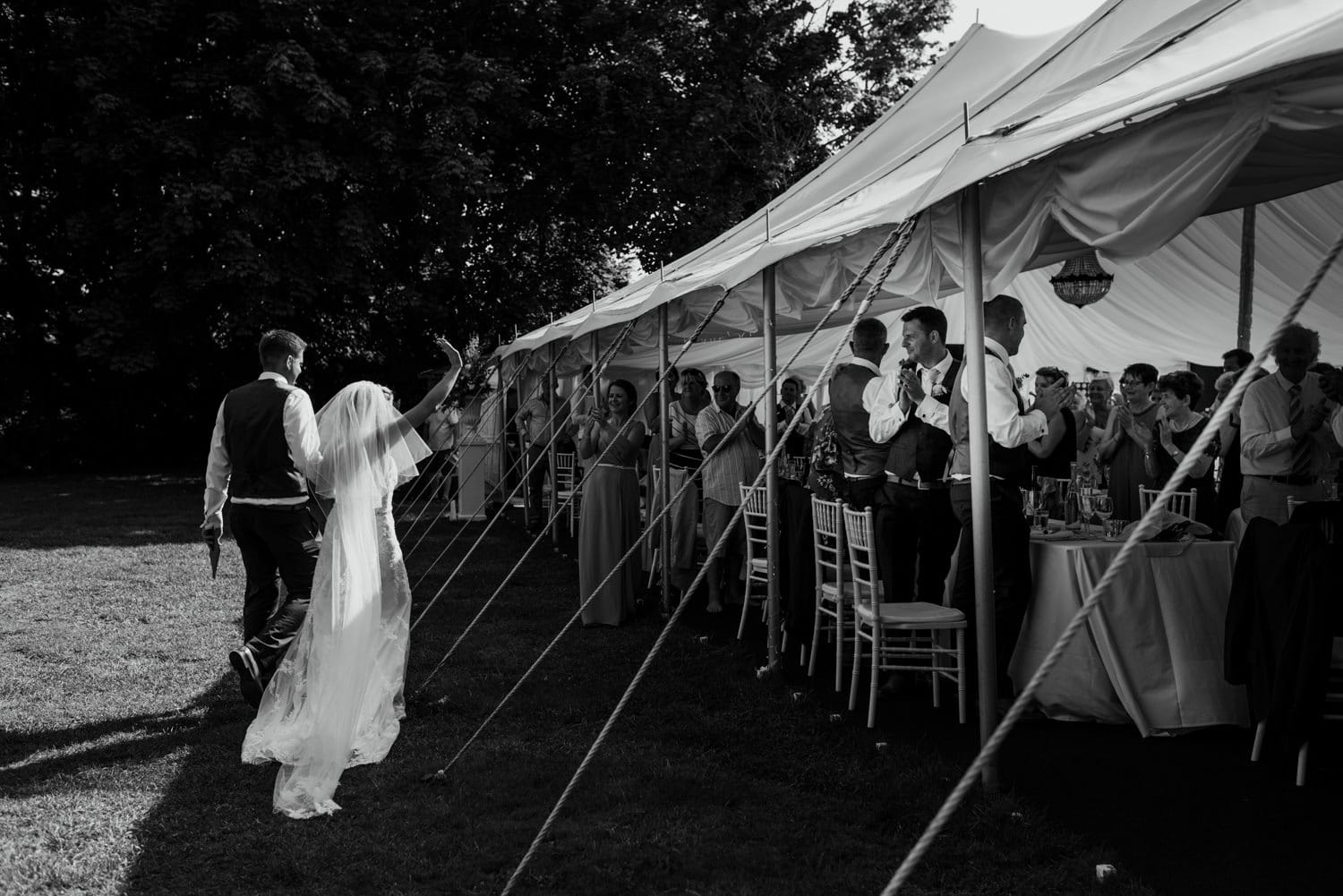 bride and groom walking to their table