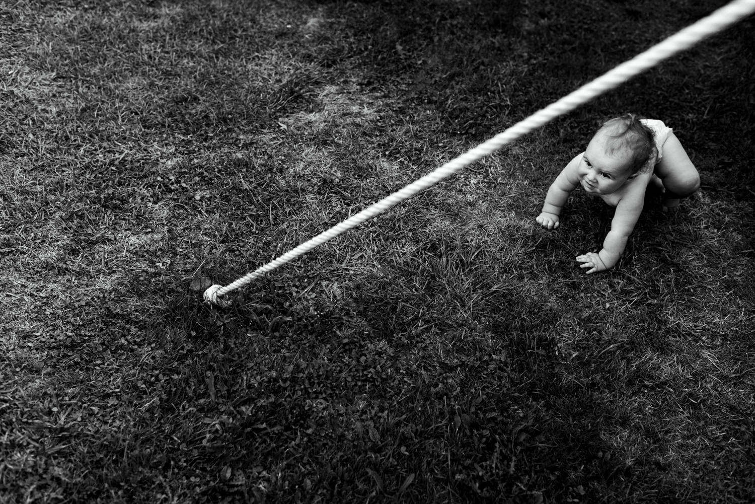 baby crawling on grass