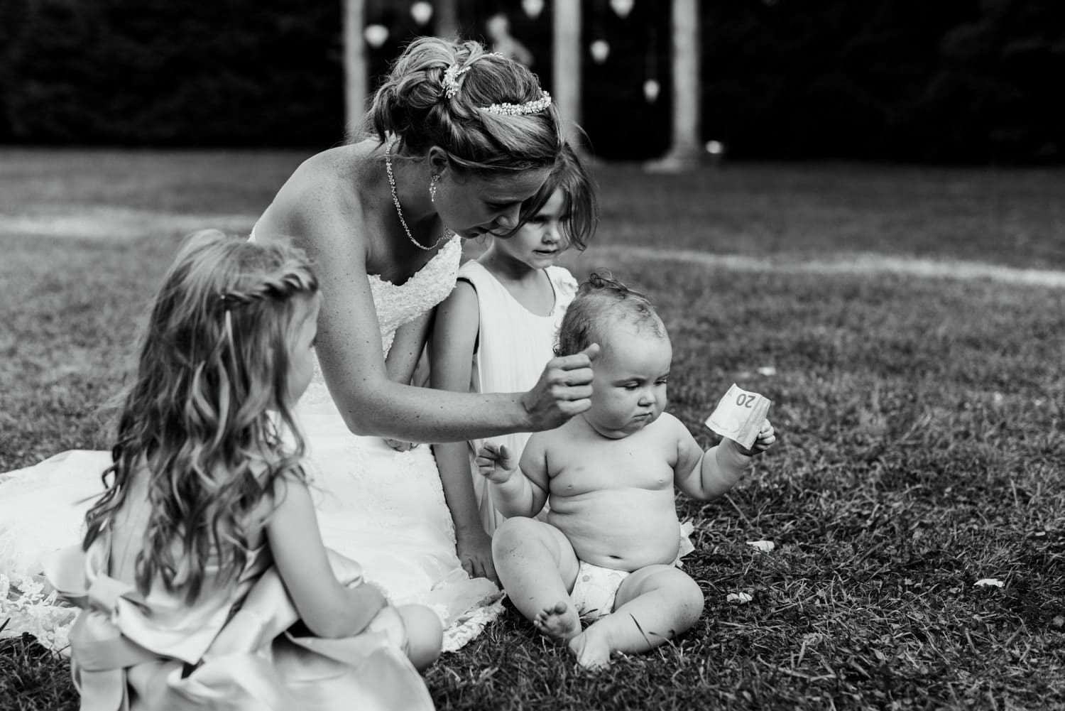 baby holding money at wedding