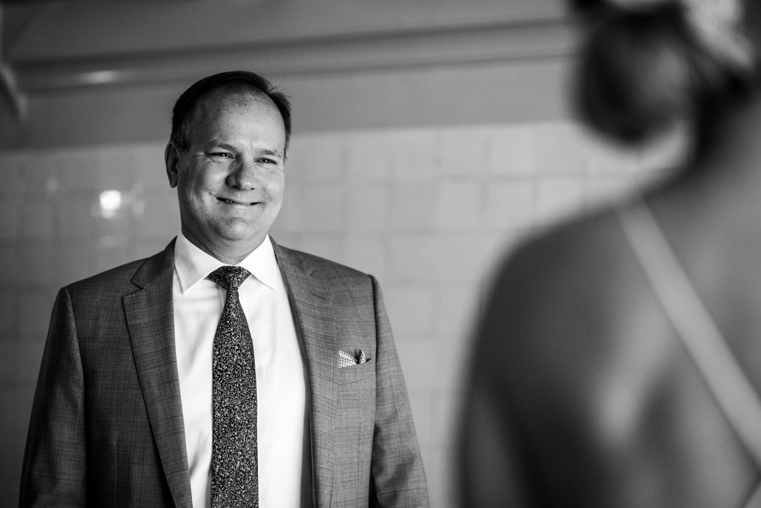 father of bride seeing his daughter in her dress for the first time