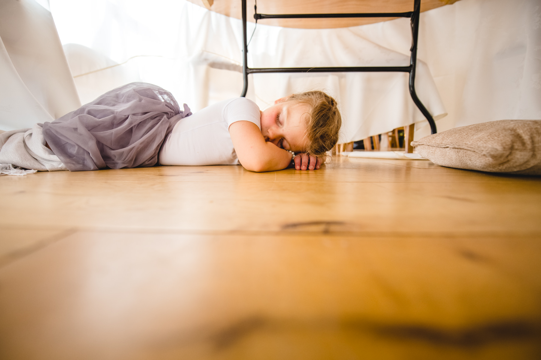 flowergirl sleeping under table